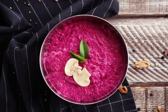 canva a bowl of beet hummus topped with leaves and mushroom MAD9bsrwqhU