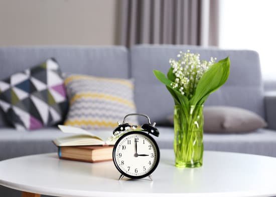canva alarm clock with bouquet of lily on table MAD QsoHzEE