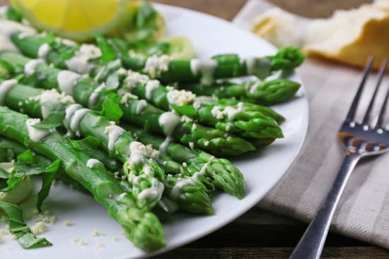canva asparagus dish with white cream on plate close up MAD Mka8zPc