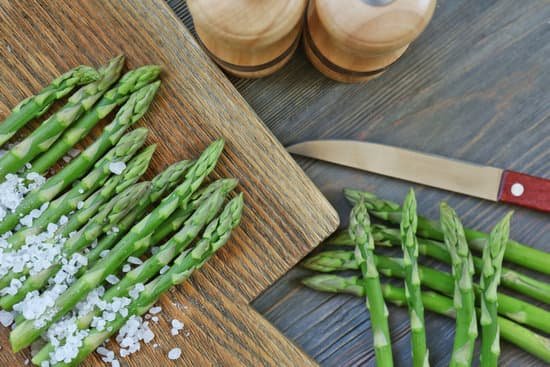 canva asparagus with knife and sea salt on cutting board MAD QlRQ7nw