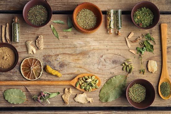 canva assorted herbs and spices on wooden background MAD Q0EPBWA