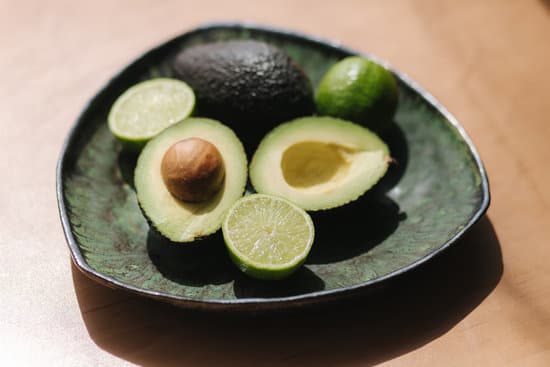 canva avocado and lime halves on green plate. MAERFVgsGQU