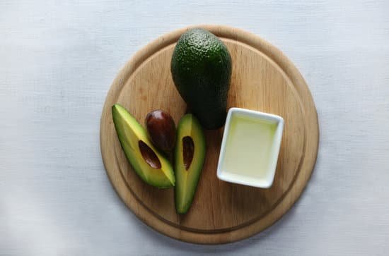 canva avocado and oil on cutting board top view MAD QqqSb1M