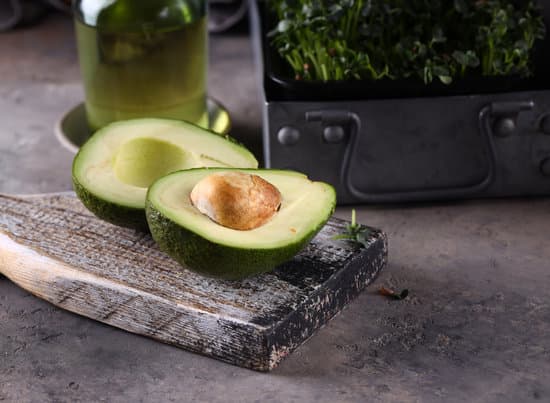 canva avocado halves on wooden board MAEONeWPH48