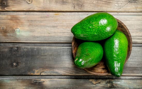 canva avocado in a wooden bowl MAEPHWSyALo