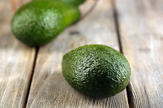 canva avocado on wooden background MAD MPTly7U