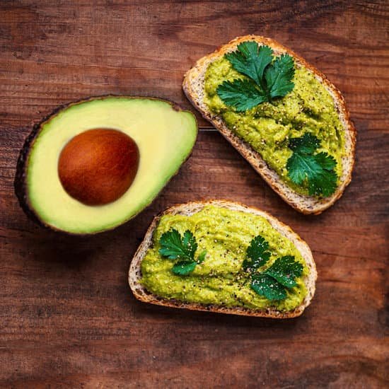 canva avocado sandwich on wooden table