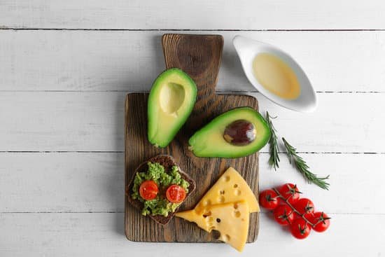 canva avocado sandwich with vegetables and cheese on wooden board MAD