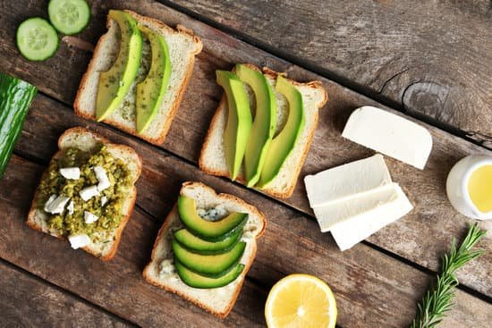 canva avocado sandwiches with lemon and cheese on wooden table MAD QgmAEPc