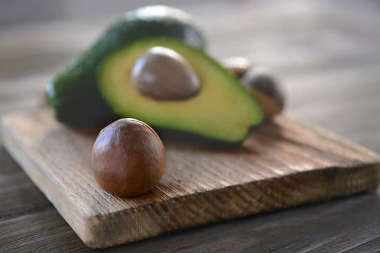 canva avocado seed on cutting board closeup MAD QhVgiUo