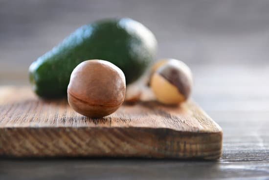 canva avocado seed on cutting board closeup MAD QqFVMig