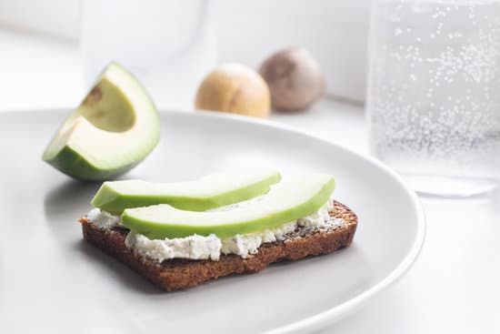 canva avocado slices and a sandwich with soft cheese and avocado on a plate MAEPkiKgQzQ