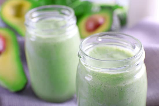 canva avocado smoothie in glass jars close up MAD QsoZzs0