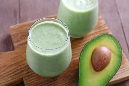 canva avocado smoothie on wooden cutting board MAD Qk1HB6Q