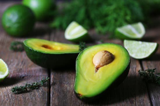 canva avocado with lime and herb on wooden table MAD MGfy3mQ