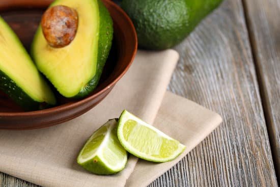 canva avocado with limes in bowl on table close up MAD MHqs2o4