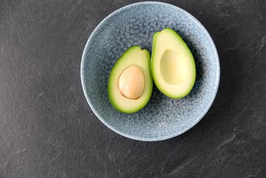 canva avocado with seed in ceramic bowl