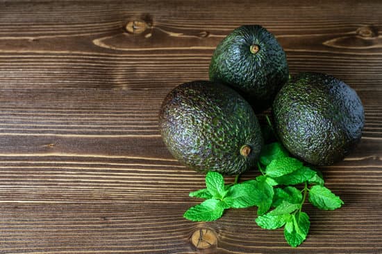 canva avocados on wooden background