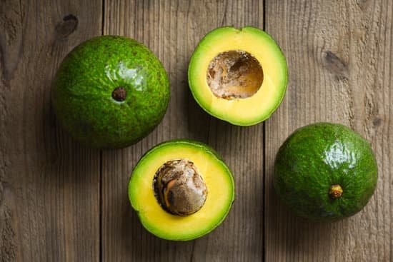 canva avocados on wooden surface MAENE8DGt3o