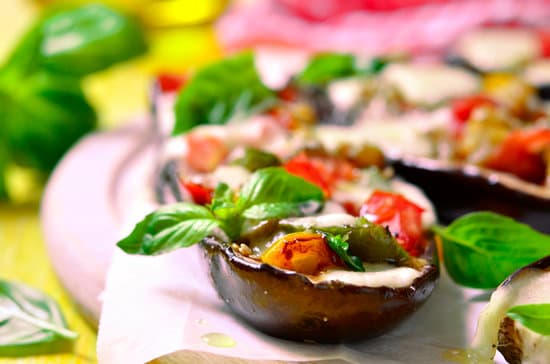 canva baked eggplants stuffed with vegetables and mozzarella cheese with herbs MAEQOZvwiRc