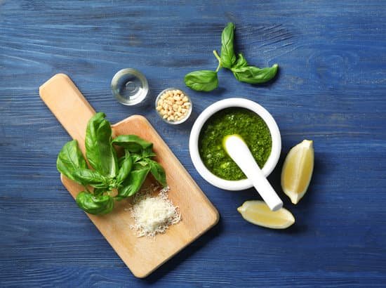 canva basil leaves on a chopping board beside a basil sauce MAD9bakjK1o