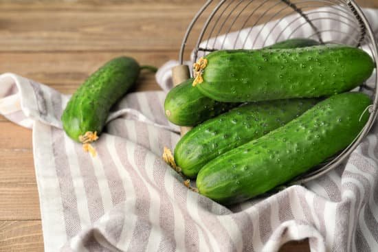 canva basket with green cucumbers on wooden table MAD6rJmmdFQ