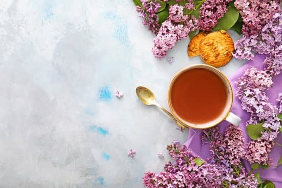 canva beautiful lilac flowers tea and cookies on a table MAD7FQX6P74