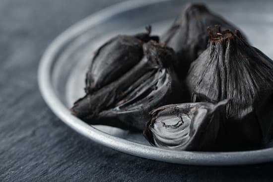 canva black garlic on a metal plate MAD8SvnZCVU
