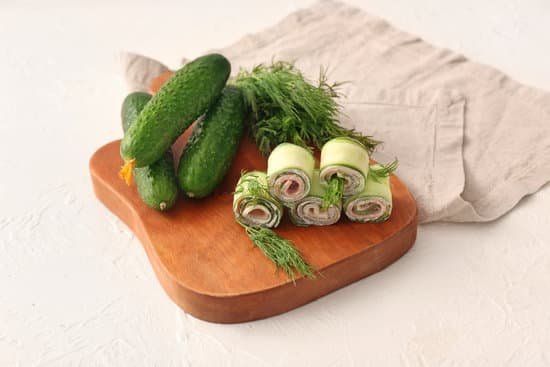 canva board with tasty cucumber rolls on white background