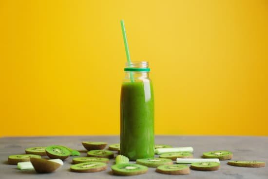 canva bottle with green smoothie sliced kiwi against yellow background MAD9aklnAyo