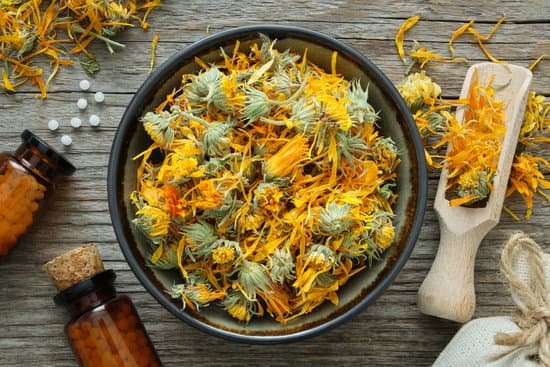 canva bottles of calendula pills and flowers in a bowl MAD