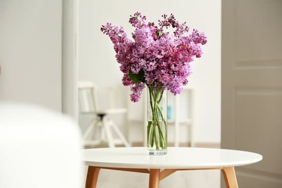 canva bouquet of purple lilac flowers on white wooden table MAD QlLRgwc