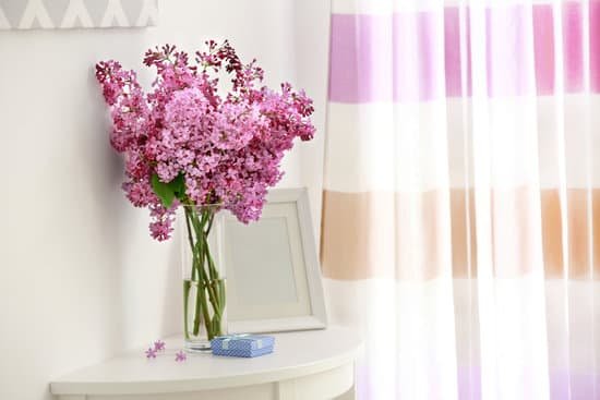 canva bouquet of purple lilac flowers on white wooden table MAD QvT6Zb0