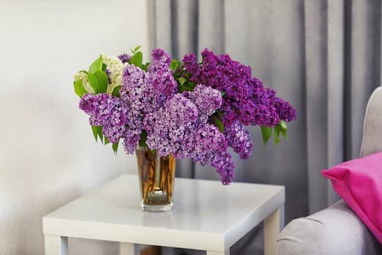 canva bouquet of spring lilac flowers on table MAD QvHtC2M