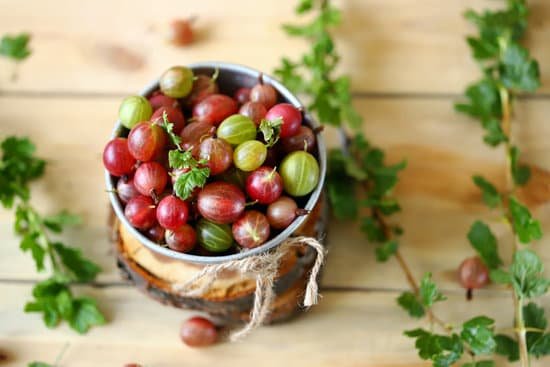 canva bowl of gooseberries on wooden surface MAEBYtf8 eA