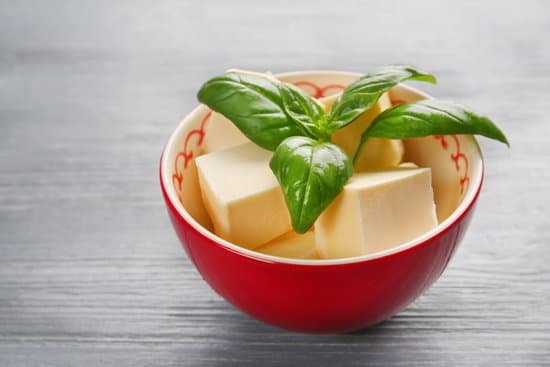 canva bowl with butter cubes and basil leaves on wooden table MAD9aj2bv3E