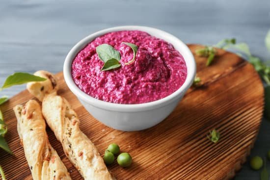 canva bowl with creamy beet hummus on wooden board MAD9bjZnvIw