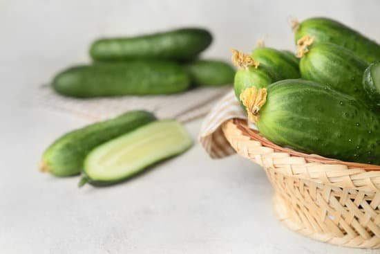 canva bowl with green cucumbers on table MAD6rL6DSag