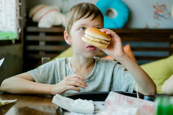canva boy eating a big burger with a cutlet. hamburger in the hand MAErkAB ock