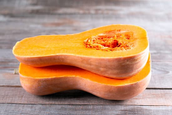 canva butternut squash sliced in half. sliced butternut squash over wood background. MAEeqwIeRQ0