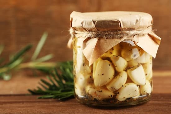 canva canned garlic in glass jar on wooden background MAD MI6PvJw