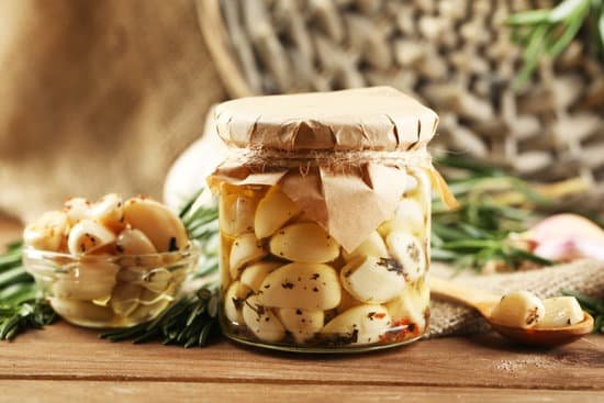 canva canned garlic in glass jar wicker mat and rosemary branches MAD