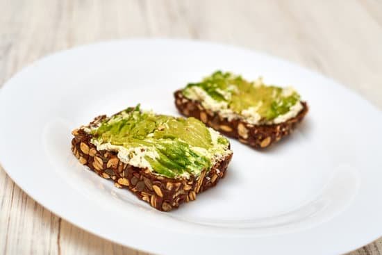 canva cereal bread with cream cheese and avocado on a plate MAEAp3c VR0