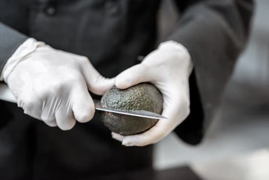 canva chef peeling an avocado in the kitchen MAECf5dBOH8
