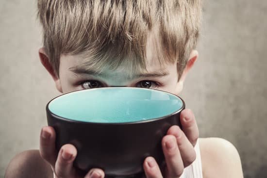 canva child holding an empty bowl hunger concept MADDJM40jTY