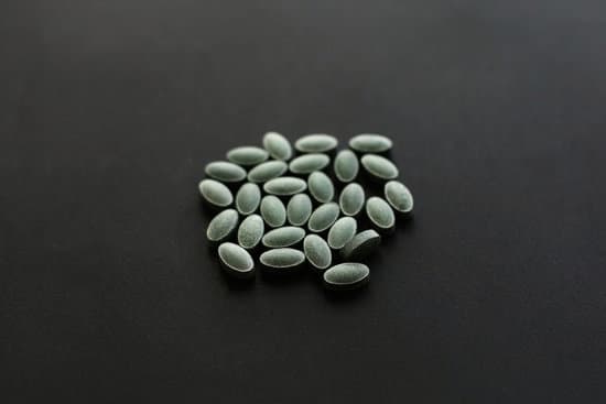 canva chlorophyll tablets on black dark background. dietary supplement MAEYTVw7OGU