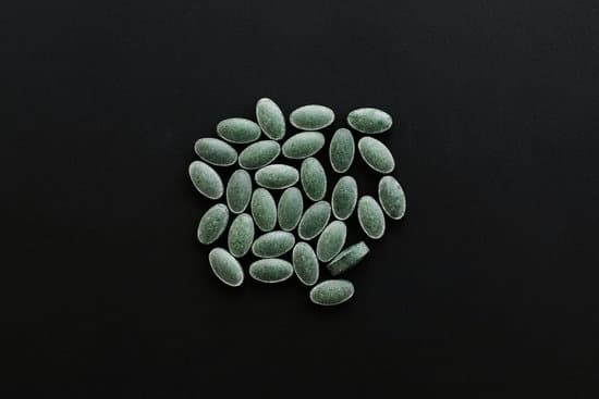 canva chlorophyll tablets on black dark background. flat lay. dietary MAEYTRL5Z5Y