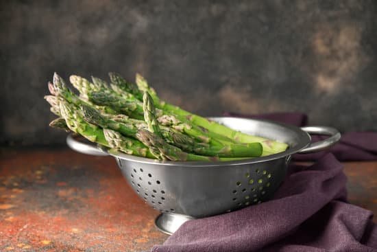 canva colander with fresh asparagus on table MAD8y3XJaNk