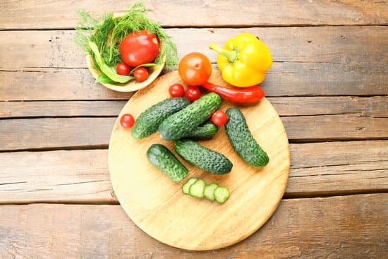 canva composition of cucumbers tomatoes and peppers on wooden background MAD MoiWJh8