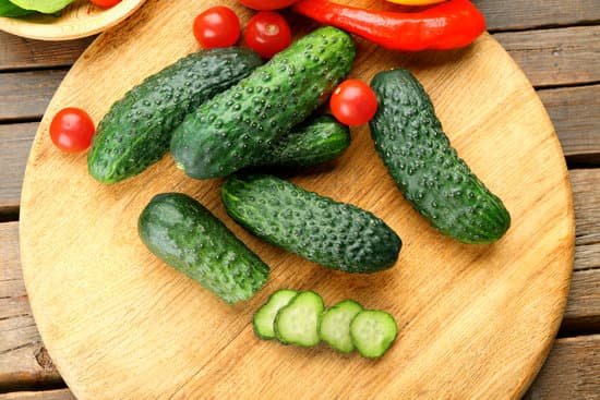 canva composition of cucumbers tomatoes and sweet pepper on wooden table MAD MjLiVUQ